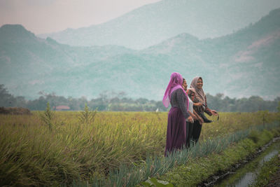 Rear view of women on field