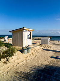 Built structure on beach against blue sky