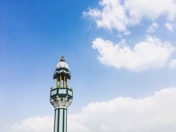 Low angle view of tower against cloudy sky