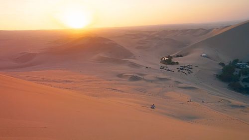 Scenic view of desert against sky during sunset