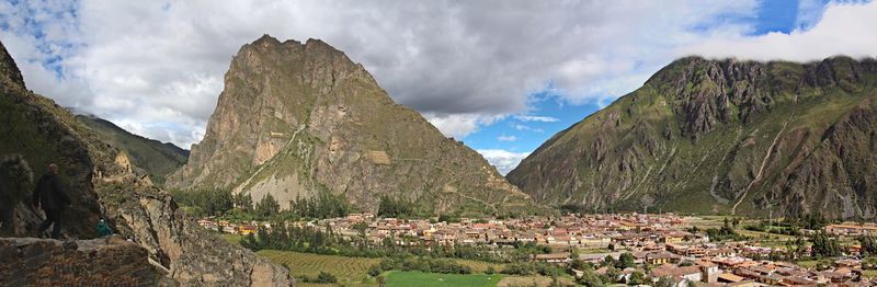 Panoramic view of townscape by mountains against sky