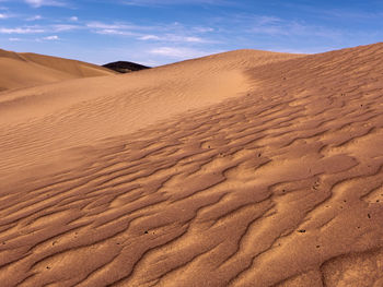 The sahara desert of morocco. the wind creates beautiful patterns in the sand and on the dunes.