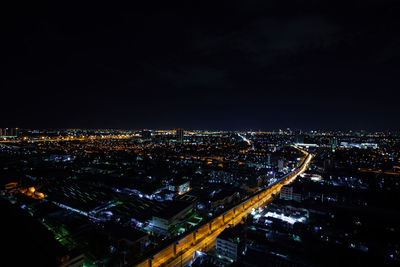 High angle view of illuminated buildings in city at night