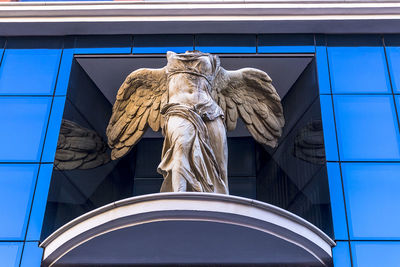 Low angle view of statue against building