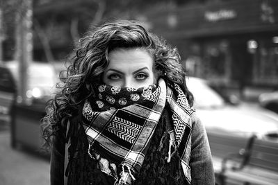 Close-up portrait of woman covering face with scarf outdoors