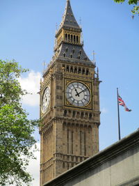 Low angle view of clock tower against sky