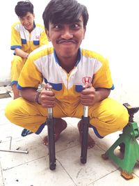 Portrait of smiling young man sitting outdoors