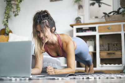 Woman using mobile phone at home