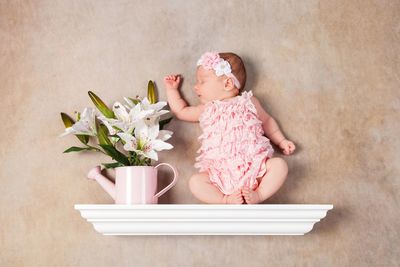 Cute baby girl with pink flower