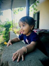 Portrait of cute boy sitting outdoors