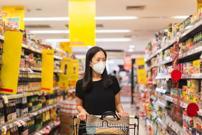 Full length of young woman standing in store