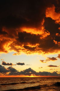 Scenic view of sea against orange sky