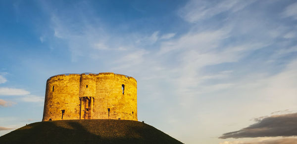 Low angle view of old fort against sky