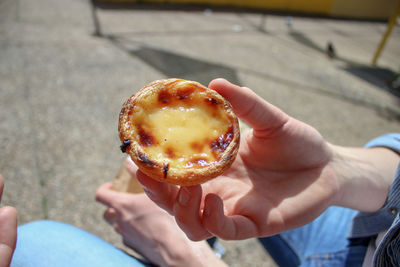 High angle view of person holding tart