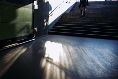 Low section of person walking on staircase