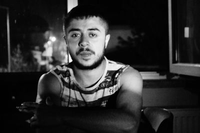 Portrait of young man sitting outdoors