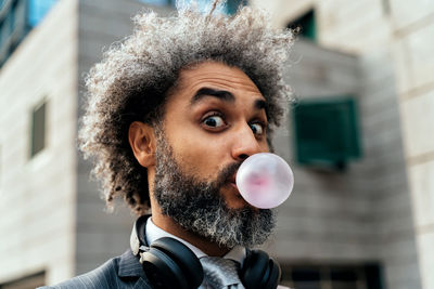 Portrait of smiling young woman blowing bubbles