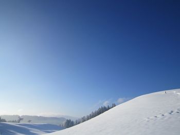 Scenic view of snowcapped mountains against clear blue sky