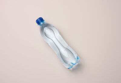 Transparent plastic bottle with fresh water, top view