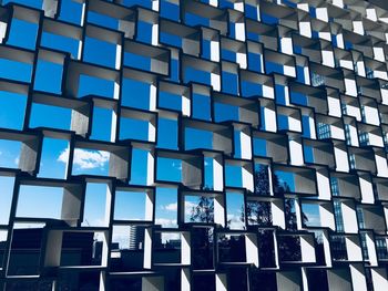 Low angle view of modern building against blue sky