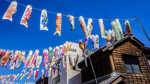 Low angle view of flags hanging against building