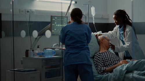 Doctor and nurse examining patient in clinic