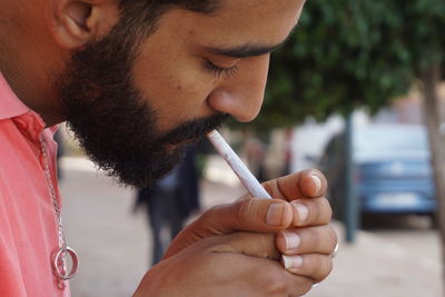 Close-up of young man smoking cigarette