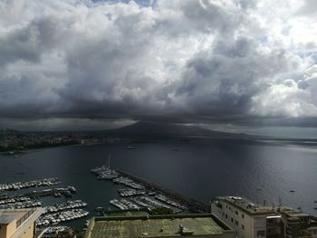 High angle view of city by sea against sky