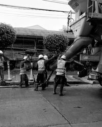 Worker pouring cement from truck at construction site