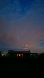 Silhouette building against sky at dusk