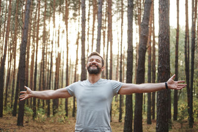 Full length of man standing in forest