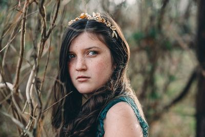 Portrait of girl against trees