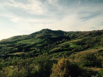 Scenic view of mountains against cloudy sky