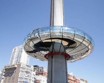 Low angle view of modern building against blue sky