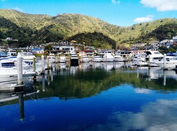 Boats moored in lake against sky