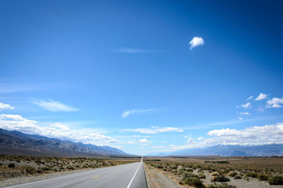 Empty road along countryside landscape