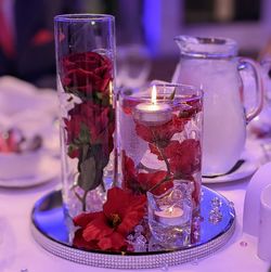 Close-up of water and flowers on table