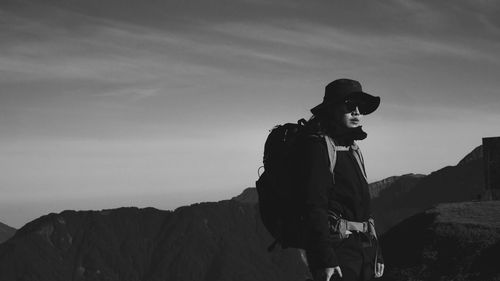 Man standing by mountains against sky