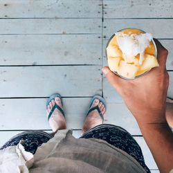 Low section of people standing on ice cream