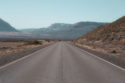 Road amidst desert against sky