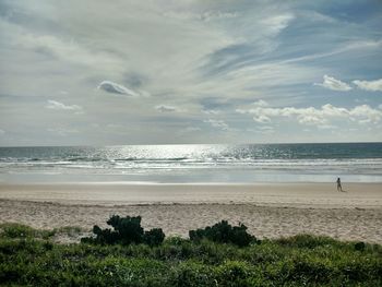 Scenic view of sea against cloudy sky