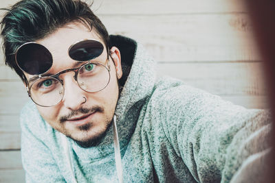 Close-up portrait of young man wearing sunglasses