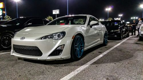 Cars parked on road at night