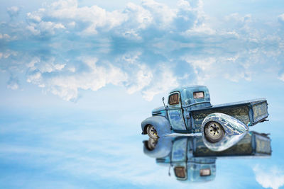 Close-up of vintage car against blue sky