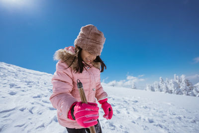 Rear view of woman standing on snow covered landscape