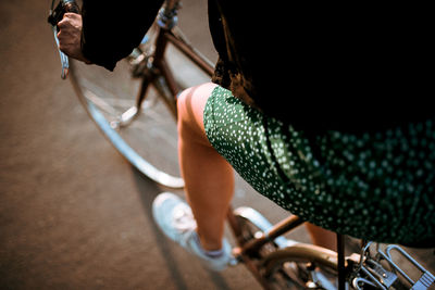 Midsection of woman riding bicycle