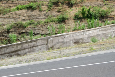 View of stone wall by road