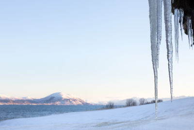 Scenic view of snowcapped mountains against clear sky