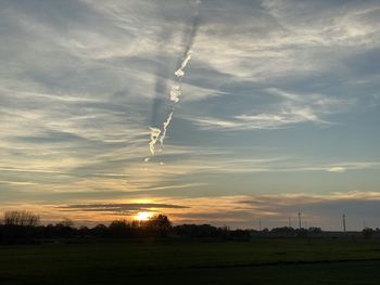 Scenic view of field against sky during sunset