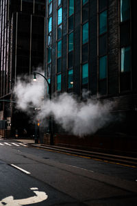 Smoke emitting from car on street